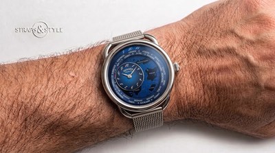Hermès Arceau world timer with a blue engraved equestrian map dial and floating satellite subdial on a Straps&Style mesh bracelet