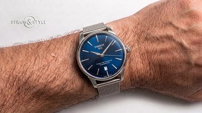 Tissot Chemin des Tourelles Powermatic 80 with a sunburst royal blue dial, polished silver case, date at six and slim baton indices on a Straps&Style mesh bracelet