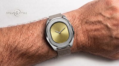 Serica avant-garde dress watch with an asymmetric pebble-shaped steel case and a champagne swirling guilloché dial on a Straps&Style mesh bracelet