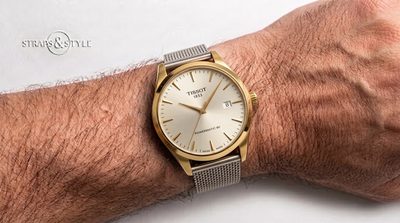 Tissot 1853 Powermatic 80 with a gold-tone case, silver sunburst dial, gold baton indices and a date window at three on a Straps&Style mesh bracelet