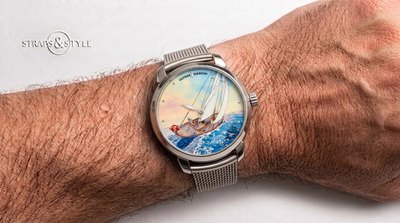Ulysse Nardin with a hand-painted enamel dial showing a sailing yacht on a blue ocean under a pastel sky on a Straps&Style mesh bracelet