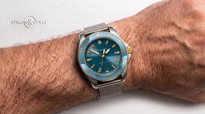 Victorinox two-tone diver with a sunburst teal-blue dial, gold-toned indices and a light blue dive bezel on a Straps&Style mesh bracelet