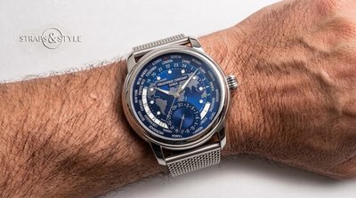 Frederique Constant worldtimer with deep blue dial, embossed world map and day-night ring on a Straps&Style mesh bracelet