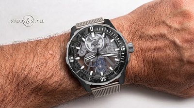 Ulysse Nardin skeletonised diver with a black forged-carbon bezel and a blue silicium balance wheel at six on a Straps&Style mesh bracelet