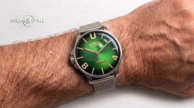 U-Boat Darkmoon with a left-hand crown, sunburst emerald green dial fading to black and a floating bubble indicator on a Straps&Style mesh bracelet