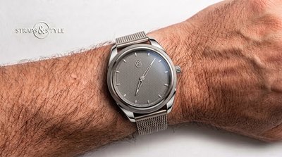 Parmigiani Fleurier ultra-thin dress watch with a slate grey guilloche dial, baton markers and small gold hands on a Straps&Style mesh bracelet