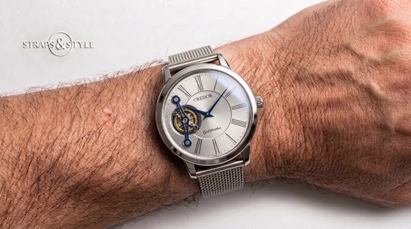 Credor Goldfeather silver dial with blued hands and open-heart balance aperture on a Straps&Style mesh bracelet