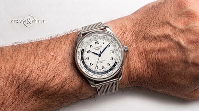 Longines Master Collection worldtimer GMT with a silver guilloché dial, city names around the chapter ring and blued steel hands on a steel mesh bracelet