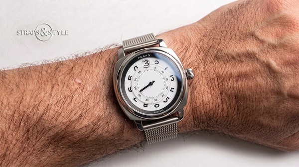 Fears cushion-case jumping-hour watch with matte white dial and single minute hand on a Straps&Style mesh bracelet
