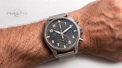 IWC Schaffhausen chronograph with a slate grey dial, vertical date aperture at three and a red-handled subdial at six on a Straps&Style mesh bracelet