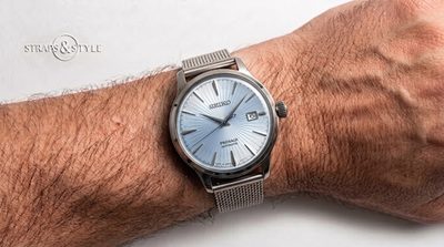 Seiko automatic with an ice-blue sunburst dial, a date window at three and a smooth polished bezel on a Straps&Style mesh bracelet