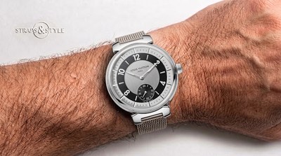 Louis Vuitton Tambour with a silver sunburst dial, black chapter ring, slim numerals and a small-seconds counter at six on a steel mesh bracelet