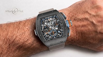 Richard Mille RM 11-05 flyback chronograph with a skeletonised dial, blue and orange accents, oversized date and GMT hand on a Straps&Style mesh bracelet