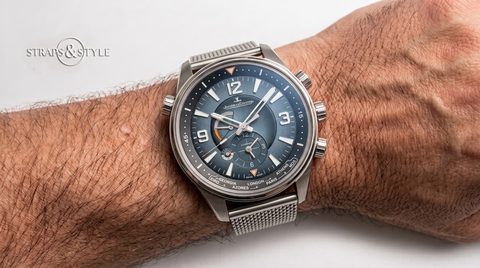 Jaeger-LeCoultre Master Control Geographic with a grey dial, luminous numerals, orange accents and a second time zone subdial on a Straps&Style mesh bracelet
