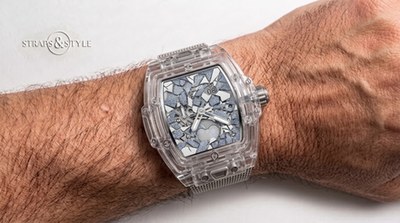 Hublot transparent tonneau watch with a mosaic blue dial, big date at twelve and moonphase at six on a Straps&Style mesh bracelet