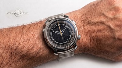Ming chronograph with a black speckled dial, a grey tachymeter ring, an orange centre seconds hand and chronograph pushers on a Straps&Style mesh bracelet
