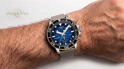 Tissot Seastar 1000 chronograph with a blue gradient dial, gold-tone dive bezel, three white subdials and a date at four on a Straps&Style mesh bracelet