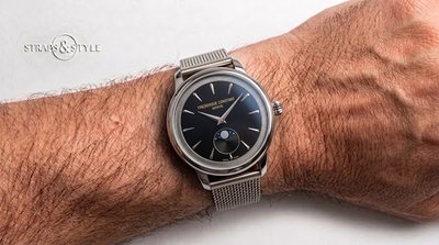 Frederique Constant round dress watch with black dial, gold lettering and moonphase at six on a Straps&Style mesh bracelet