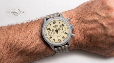 Hanhart cream-dial flyback chronograph with two subdials and a coin-edge bezel marked with a red dot on a Straps&Style mesh bracelet