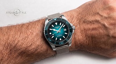 Longines Hydroconquest diver with a teal gradient dial, teal-accented rotating dive bezel, luminous markers and a date at three on a steel mesh bracelet