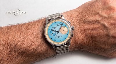 Studio Underd0g chronograph with a sky blue dial, cream tachymeter ring, peach subdial at three and a second subdial at nine on a Straps&Style mesh bracelet