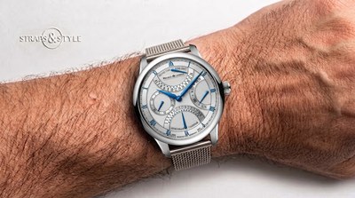Maurice Lacroix Masterpiece retrograde calendar with a silver dial, blue skeleton hands, retrograde date, day and second time zone sub-dials on a Straps&Style mesh bracelet