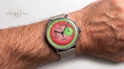 Studio Underd0g chronograph with a watermelon red dial, light green tachymeter ring and two subdials at three and nine on a Straps&Style mesh bracelet