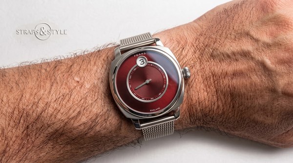 Fears jumping-hour watch with ruby-red dial and concentric grooving on a Straps&Style mesh bracelet