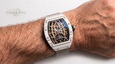Richard Mille tourbillon in a white ceramic tonneau case with a rose-gold open-lattice bridge, tourbillon at six and power-reserve indicator on a Straps&Style mesh bracelet