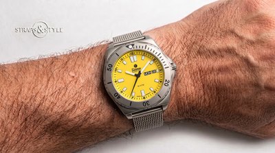 Tutima Glashütte/SA diver with a bright yellow dial, day-date at three and a 50 ATM rotating bezel on a Straps&Style mesh bracelet