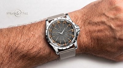 Roger Dubuis Knights of the Round Table watch with a charcoal dial engraved with Celtic knotwork and twelve miniature gold knights as hour markers on a Straps&Style mesh bracelet