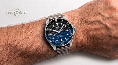 Mido Ocean Star Caliber 72 diver with a black and blue wave-pattern dial, two-tone dive bezel, date at three and a steel mesh bracelet on the wrist