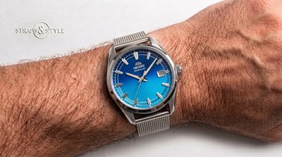 Orient automatic with a gradient blue pinstriped dial and a date at three on a Straps&Style mesh bracelet