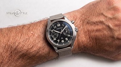 Vertex military pilot chronograph with a matte black dial, twin subdials at three and nine and a broad arrow above six on a Straps&Style mesh bracelet