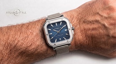 Michel Herbelin Cap Camel automatic with a striped blue dial, date at six and a stainless steel mesh bracelet on the wrist