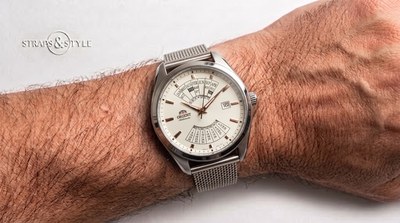 Orient automatic with a cream dial, rose-gold indices, a month and year table at twelve and a weekday and date grid at six on a Straps&Style mesh bracelet