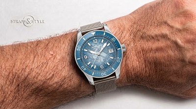 Montblanc diver with a blue textured glacier dial, white luminescent numerals, a date at three and a matching blue dive bezel on a Straps&Style mesh bracelet
