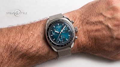 Tissot chronograph with a teal blue gradient dial, a black tachymeter bezel, three subdials and a cushion-shaped steel case on a Straps&Style mesh bracelet