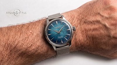 Seiko Presage automatic with a textured teal blue enamel-style dial, sharp silver hands and a date at three on a Straps&Style mesh bracelet